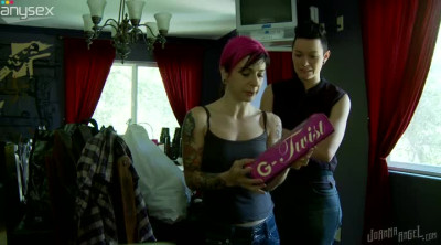 Pink haired punk bitch sits on gal's laps and stimulate clit with toy