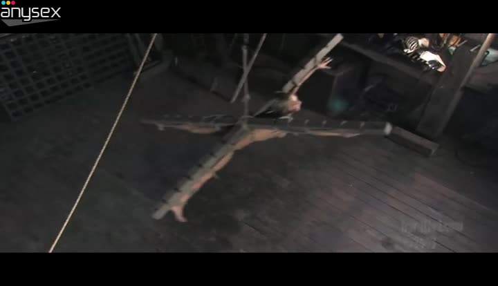 Crucified blond head is fixed with ropes to wooden bars and hung above the floor Free Porn Videos | ePornAny.