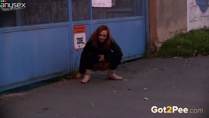 Kinky shameless redhead squats down to piss outdoors on the grass Free Porn Videos | ePornAny.