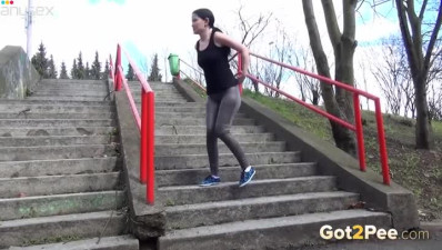 Raven haired filthy girl finds pissing on stairs very captivating