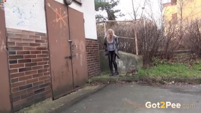 Wanton blond haired cutie adores pissing near garage