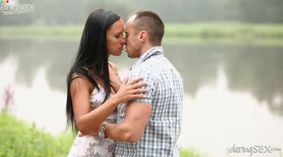 Romantic couple having sensual sex near the lake