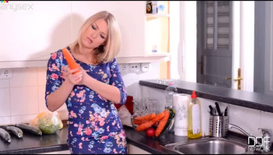 Crazy housewife gets horny and fucks her muff with carrot in the kitchen