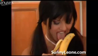 Busty brunette with pigtails Sunny Leone fucks her pussy with banana