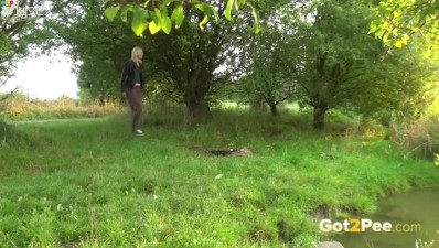 Long legged blond girlie pissed in woods near pond