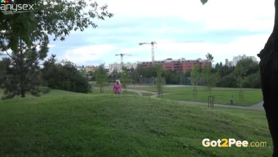 Pretty blond wench in pink t-shirt pisses on green grass while going to work