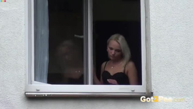 Bitchy blond hooker pisses sitting on window sill