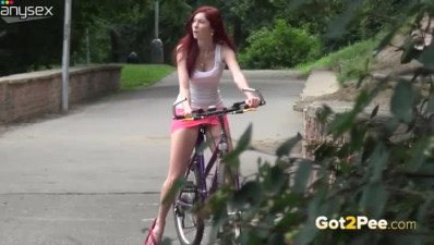 Red haired biker girlie in pink mini skirt pisses on sidewalk