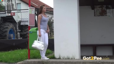 Freaky brunette chick in white jeans pissed on bus stop