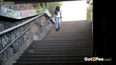 Sizzling dark haired wench pisses in underground early in the morning