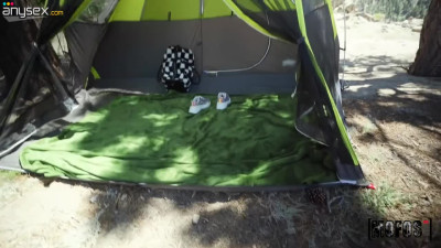 Two camping babes are making love in a tent