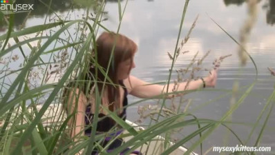 Pale skinned girl Anouk is playing with her clam in the boat