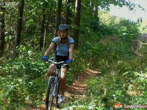 Booty blonde is posing near her bike deep in the forest