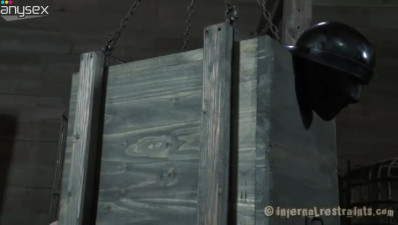 Freaky lady Elise Graves is in the wooden box with a hook in her ass