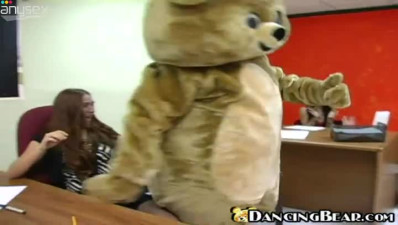 Dancing bear entertains girls in the office on a casual day