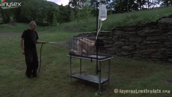 Juliette March is outside in the cage getting sprayed with cold water Free Porn Videos | ePornAny.