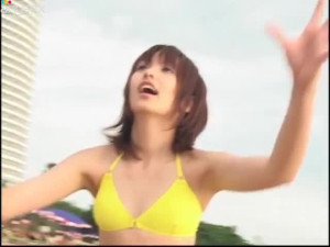 Akina Minami in bikini playing on the sand