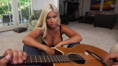 Black girlie Bridgette B sucks a guitarist's lollicock