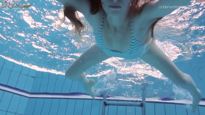 Red haired teen Anna Netrebko is undressing under the water